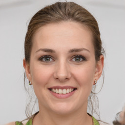 Joyful white young-adult female with medium  brown hair and green eyes