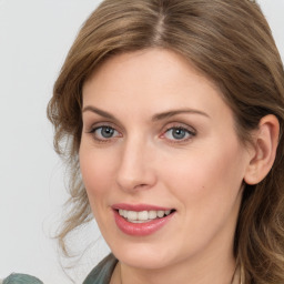 Joyful white young-adult female with medium  brown hair and blue eyes