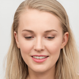 Joyful white young-adult female with long  brown hair and blue eyes