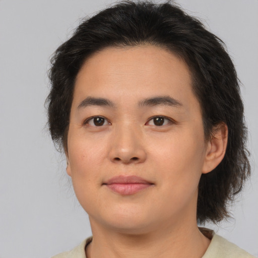 Joyful asian young-adult female with medium  brown hair and brown eyes