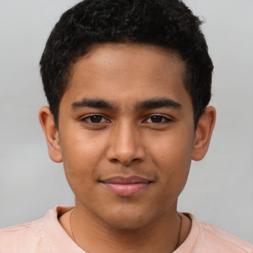 Joyful latino young-adult male with short  black hair and brown eyes