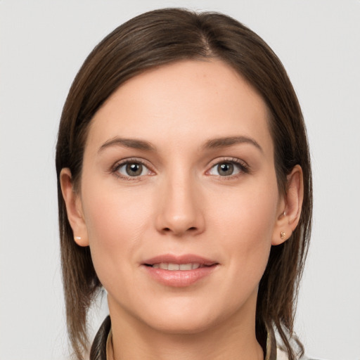 Joyful white young-adult female with long  brown hair and grey eyes