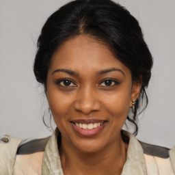 Joyful black young-adult female with medium  brown hair and brown eyes