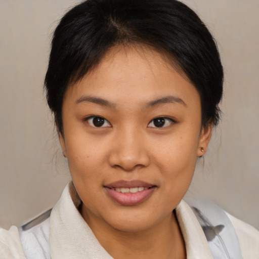 Joyful asian young-adult female with medium  brown hair and brown eyes