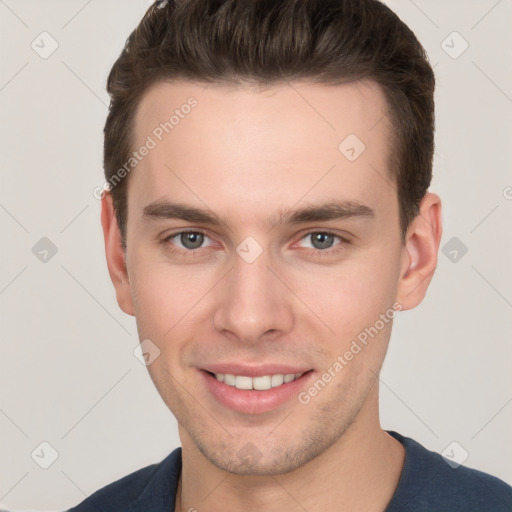 Joyful white young-adult male with short  brown hair and grey eyes