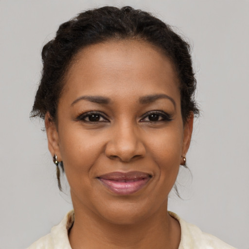 Joyful latino adult female with medium  brown hair and brown eyes