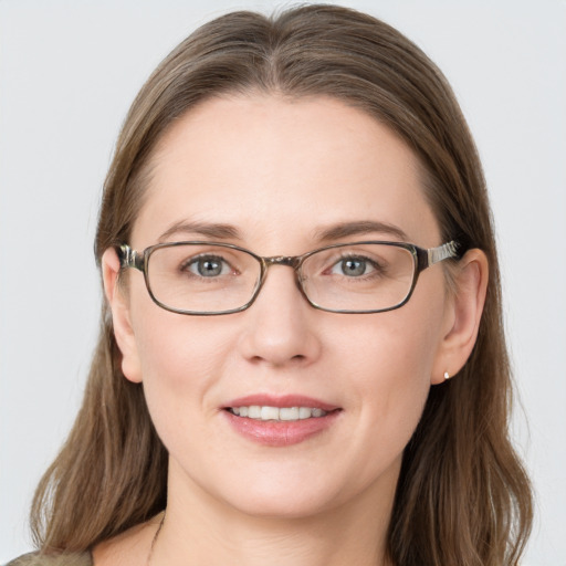 Joyful white young-adult female with long  brown hair and grey eyes