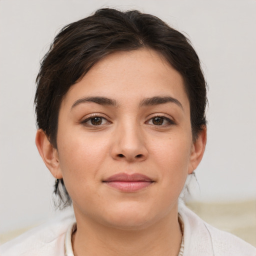 Joyful white young-adult female with short  brown hair and brown eyes