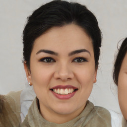 Joyful asian young-adult female with medium  brown hair and brown eyes