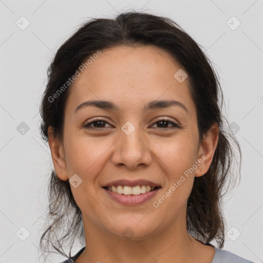 Joyful latino young-adult female with medium  brown hair and brown eyes