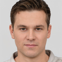 Joyful white young-adult male with short  brown hair and grey eyes