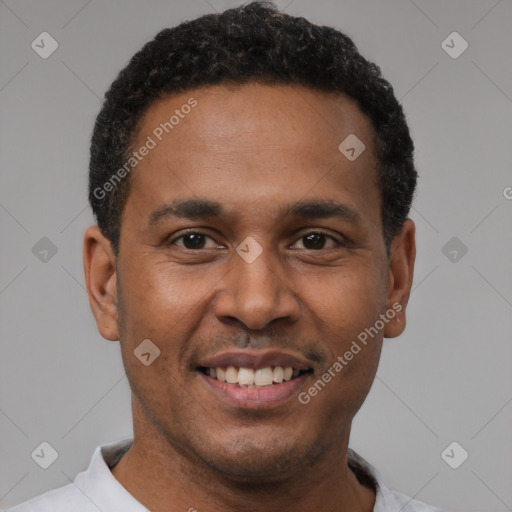 Joyful latino young-adult male with short  brown hair and brown eyes