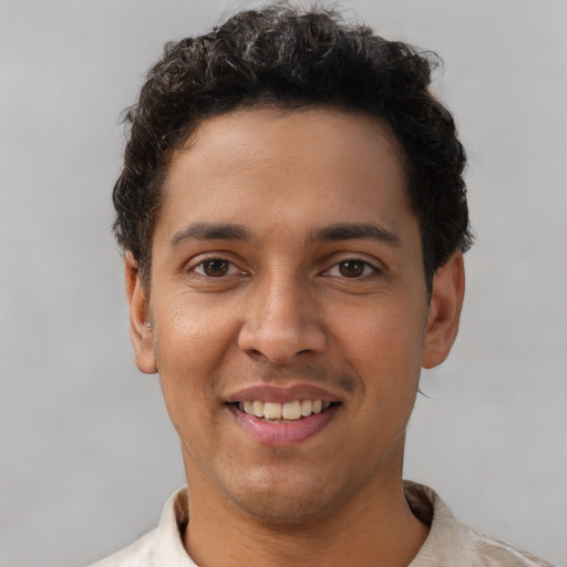 Joyful latino young-adult male with short  brown hair and brown eyes