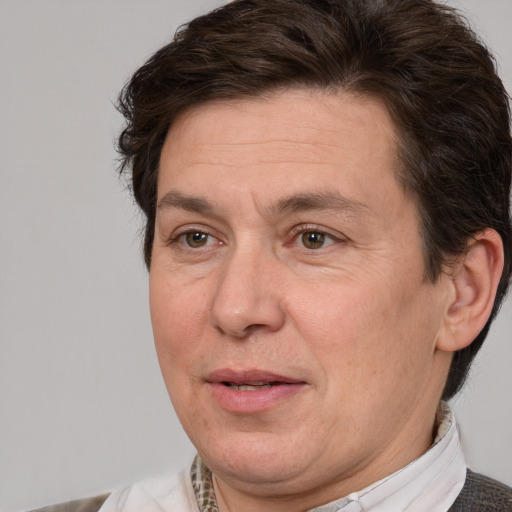 Joyful white adult male with medium  brown hair and brown eyes