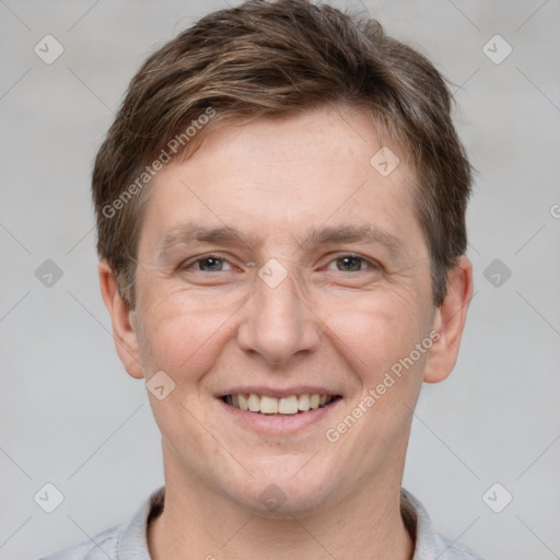 Joyful white adult male with short  brown hair and grey eyes