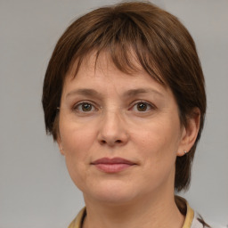 Joyful white adult female with medium  brown hair and grey eyes