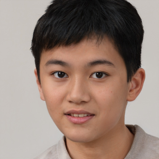 Joyful asian child male with short  brown hair and brown eyes