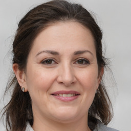 Joyful white adult female with medium  brown hair and brown eyes