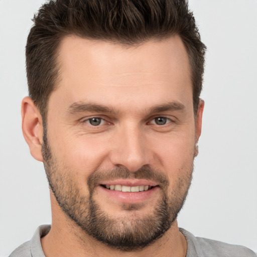 Joyful white young-adult male with short  brown hair and brown eyes