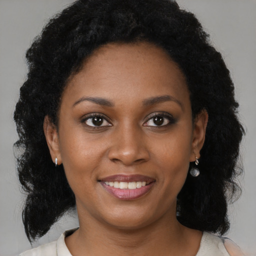 Joyful black young-adult female with medium  brown hair and brown eyes