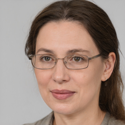 Joyful white adult female with medium  brown hair and grey eyes