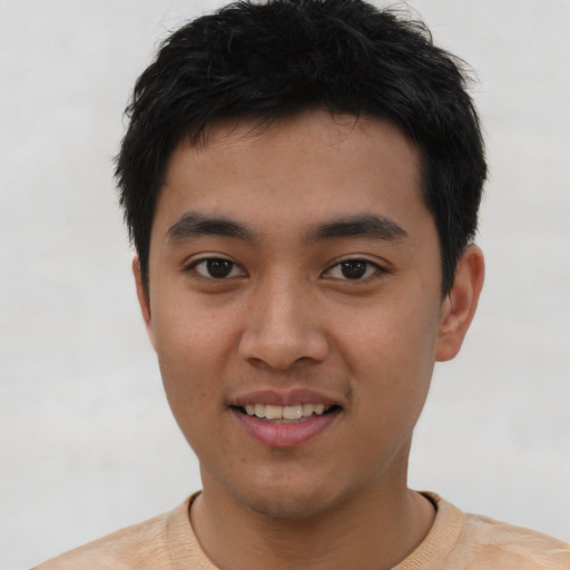 Joyful asian young-adult male with short  black hair and brown eyes
