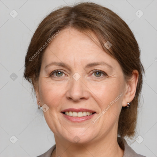 Joyful white adult female with medium  brown hair and grey eyes