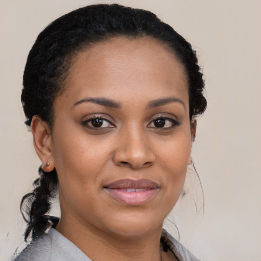 Joyful black young-adult female with medium  brown hair and brown eyes