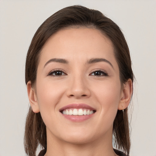 Joyful white young-adult female with medium  brown hair and brown eyes