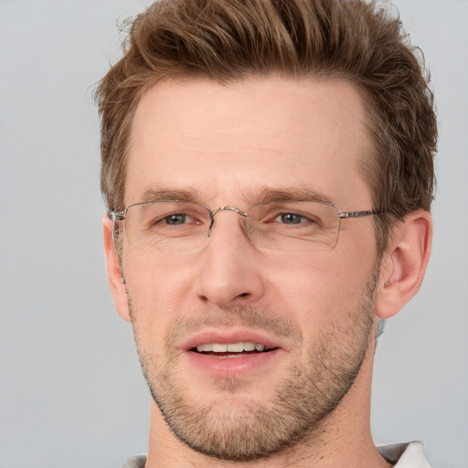 Joyful white adult male with short  brown hair and grey eyes