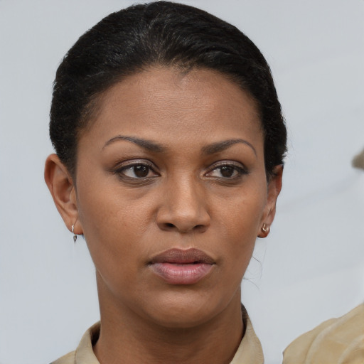 Joyful black young-adult female with short  brown hair and brown eyes