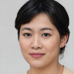 Joyful asian young-adult female with medium  brown hair and brown eyes