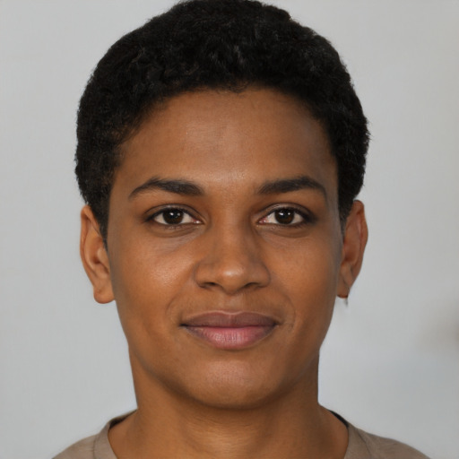 Joyful black young-adult female with short  black hair and brown eyes