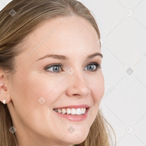 Joyful white young-adult female with long  brown hair and blue eyes