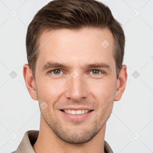 Joyful white young-adult male with short  brown hair and grey eyes