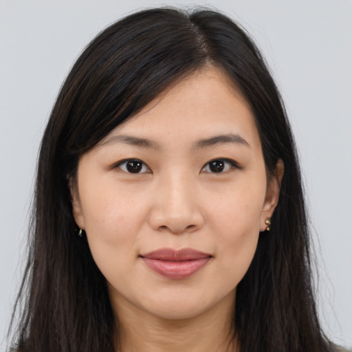 Joyful asian young-adult female with long  brown hair and brown eyes