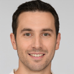 Joyful white young-adult male with short  brown hair and brown eyes