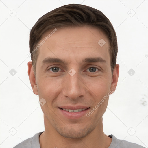 Joyful white young-adult male with short  brown hair and grey eyes