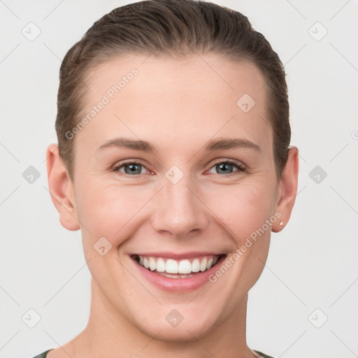 Joyful white young-adult female with short  brown hair and grey eyes