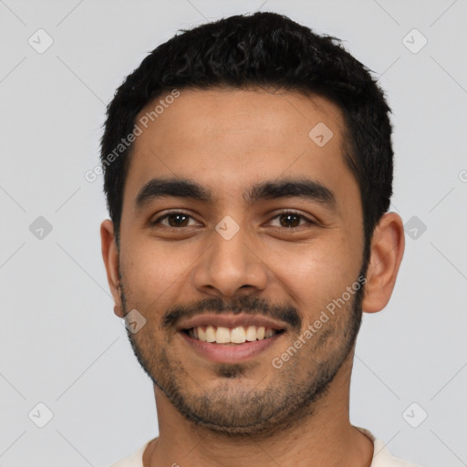 Joyful latino young-adult male with short  black hair and brown eyes