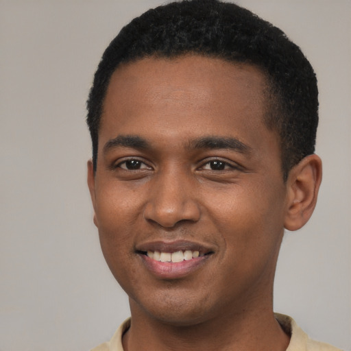 Joyful black young-adult male with short  brown hair and brown eyes