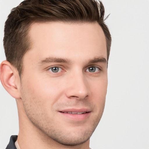 Joyful white young-adult male with short  brown hair and grey eyes