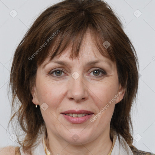 Joyful white adult female with medium  brown hair and grey eyes