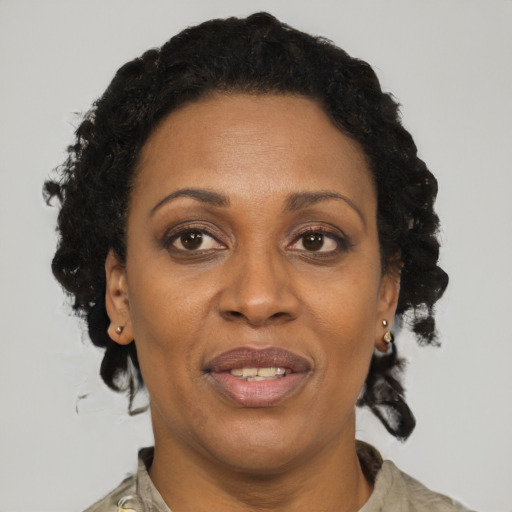 Joyful black adult female with short  black hair and brown eyes