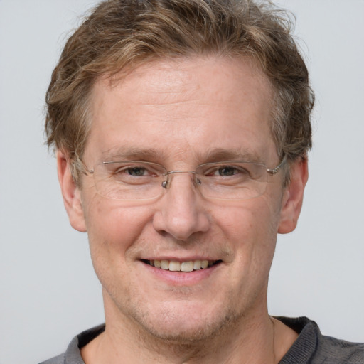 Joyful white adult male with short  brown hair and grey eyes