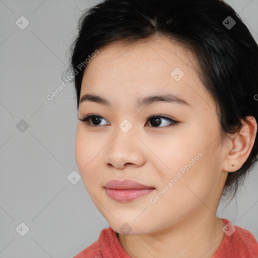 Joyful asian young-adult female with long  brown hair and brown eyes