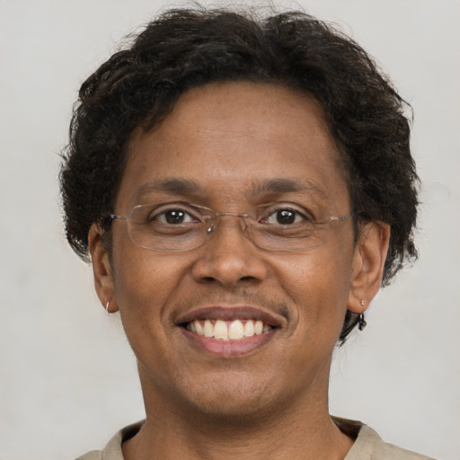 Joyful black adult male with short  brown hair and brown eyes