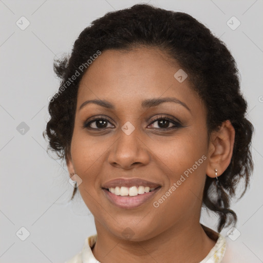 Joyful black young-adult female with medium  brown hair and brown eyes