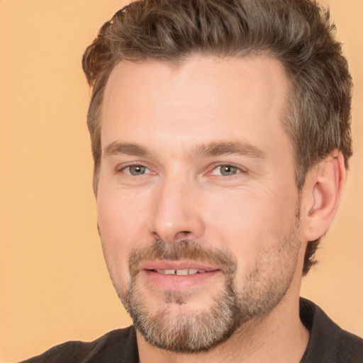 Joyful white adult male with short  brown hair and brown eyes