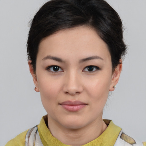 Joyful asian young-adult female with short  brown hair and brown eyes